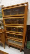 A 1950's oak Staverton bookcase cabinet with five glazed doors and Wellington style side plate