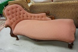 A Victorian mahogany show framed chaise longue with button back and pink upholstery