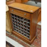 A walnut and cross-banded wine cabinet with single drawer over a 36 bottle rack,