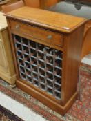 A walnut and cross-banded wine cabinet with single drawer over a 36 bottle rack,