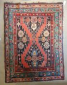 A Caucasian rug, the central panel with red and black ground within a stepped red,