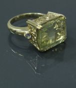 A 9 carat gold dress ring set with emerald cut citrine flanked by two further stones, ring size P/Q,