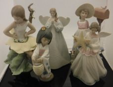 A collection of Lladro figures including "Angel", "Flower Fairy", "Oriental Lantern",