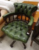 A modern green buttoned leather upholstered swivel office armchair in the Victorian style