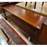 A modern mahogany sideboard with two sliding doors raised on chrome feet