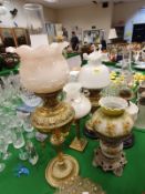 Four various Victorian brass and glass oil lamps together with a corinthian column type brass table