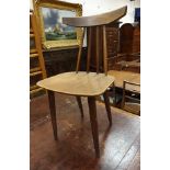 A set of four mid 20th Century teak stick back dining chairs on turned supports,