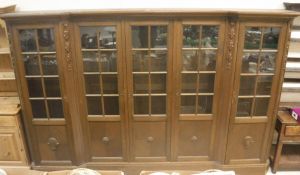A Continental oak breakfront bookcase cabinet in the Victorian manner,