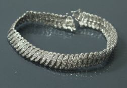 A 9 carat white gold and diamond set bracelet of fancy link form, 16.