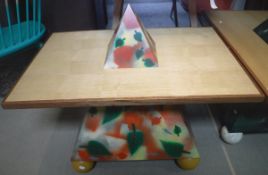 A Horus type coffee table of pyramid design painted with falling leaves,