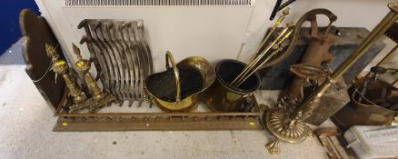 A set of three engraved brass fire irons, brass coal helmet, pair of brass fire dogs,