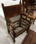 A 19th Century walnut elbow chair frame with carved head finials