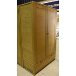 An Ercol oak two door wardrobe with single drawer to base (to match Lot 498) Dimensions (Approx):
