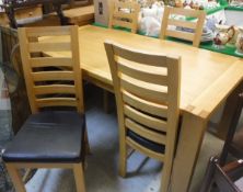 A modern oak rectangular dining table and four ladder back chairs with upholstered seats (ex TR