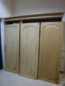 A Victorian pine triple wardrobe compactum with hanging space,