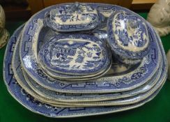 Five blue and white "Willow" pattern serving platters, two sauce tureens and covers,