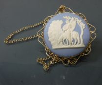 A 9 carat gold mounted circular Wedgwood Jasper ware pendant and 9 carat gold chain,