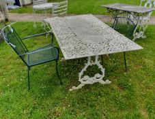 A modern pierced and painted metal rectangular garden table and two modern green painted metal