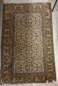 A Caucasian rug, the central panel set with all-over floral design on a cream ground,