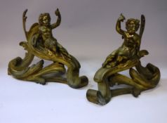 A pair of 20th Century gilt brass Chenets (fire decorations) as putti holding aloft a bird amongst