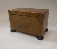 A 19th Century walnut and cross banded tea caddy,