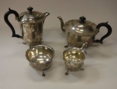 A George V silver four piece tea set comprising teapot, hot water jug, sugar bowl and milk jug,