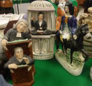 A 19th Century Staffordshire figure group "The Vicar and Moses" another "Spurgeon" and another