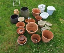 A collection of various garden pots and enamel wares