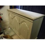 A modern painted three door side cabinet in the 19th Century Continental style,