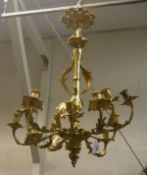 A twelve branch ormolu chandelier of scrolling acanthus design in the 18th Century Rococo taste