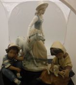 A pair of Lladro ornaments "Young Boy in Cap" and "Young Girl feeding Lamb" (2223),