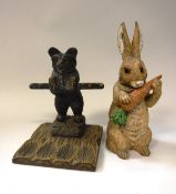 An early 20th Century carved pine pipe stand decorated with a bear in the Black Forest manner