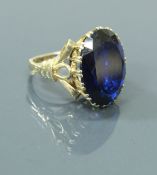 A 9 carat gold dress ring set with large blue facet cut stone, 9.