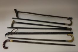 A collection of nine various walking canes including rosewood example with gold ferule,