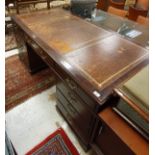 A 20th Century mahogany double pedestal desk with tooled and gilded leather insert over three
