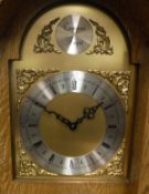 A modern oak cased long case clock of small proportions the brass dial with silvered chapter ring