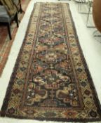 A Caucasian runner, the central panel set with repeating medallions on a dark brown ground,