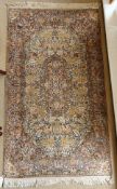 A fine Oriental rug, the central panel set all over floral decoration on a pink and cream ground,