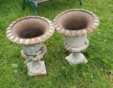 A pair of painted cast iron garden urns