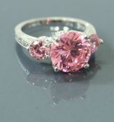 A 9 carat white gold dress ring set with three pink stones, ring size O, 4.