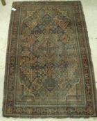 A Caucasian rug, the central panel set with diamond medallion within a tiled dark blue,