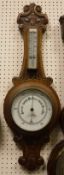 A late Victorian oak cased banjo barometer with mercury thermometer by Aitchison of London &