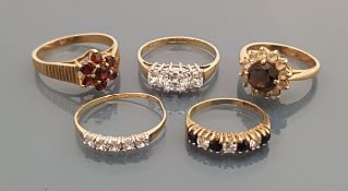 A collection of five 9 carat gold stone set rings,
