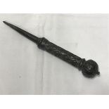 A cast iron spike with lozenge decorated handle and decorative pommel (possibly a sword handle of