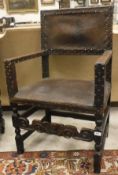 A 17th Century elbow chair with leather back and seat, with studded decoration,