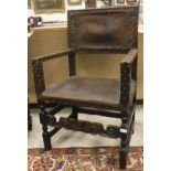 A 17th Century elbow chair with leather back and seat, with studded decoration,