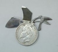 A Napoleon III 1869 5 franc piece coin concealing scissors, knife and file,