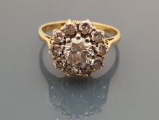 An 18 carat gold diamond set cluster ring, the central stone approx 0.
