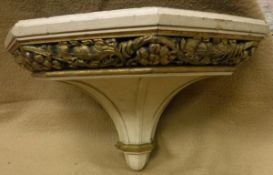 A large cream painted and gilded oak wall bracket in the Classical style with grape and vine