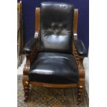 A Victorian salon elbow chair with show frame and buttoned leather back and seat and arms,